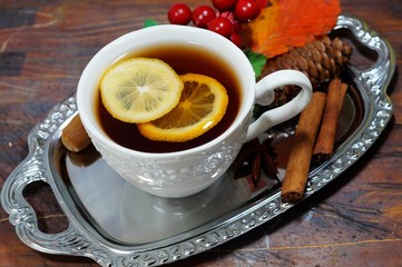 hot tea with lemon in autumn and winter evenings - a festive table
