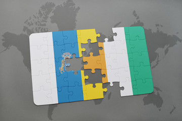puzzle with the national flag of canary islands and cote divoire on a world map background.