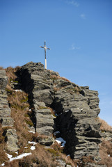 Fototapeta premium Christian rood on the summit of rock