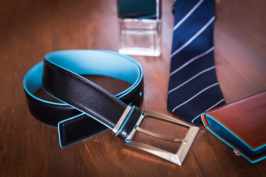 Men fashion accessories. Men wallet, belt, and tie. Still life. Business look.