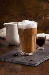 Iced latte, espresso shot and creamer are together.