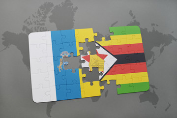 puzzle with the national flag of canary islands and zimbabwe on a world map background.