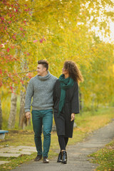 Fototapeta premium beautiful couple in the autumn forest. Curly girl