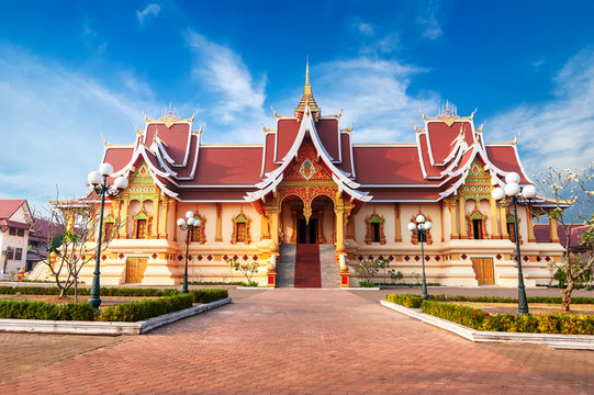 Asian architecture. Outdoor park with Buddhist Society Hall at Pha That Luang complex. Vientiane, Laos,  travel landscape and destinations
