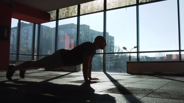 Man execute push ups  in fitness gym