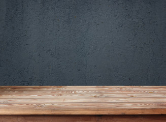 Empty wooden table against the background of an old wall.