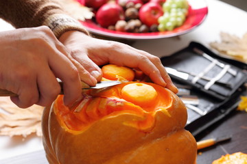 Carving out a pumpkin to prepare halloween lantern