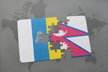 puzzle with the national flag of canary islands and nepal on a world map background.