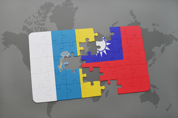 puzzle with the national flag of canary islands and taiwan on a world map background.