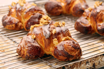 Croissant stuffed with walnuts on wooden background