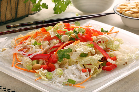 Fresh healthy asian salad with rice noodles and nuts