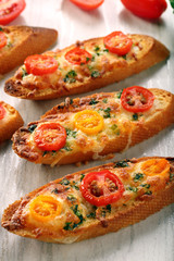 Fresh crispy toast with cheese and tomatoes on white background