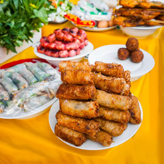 Traditional spicy asian food at street market. Meat balls, spring rolls and curry chicken on grill. Laos