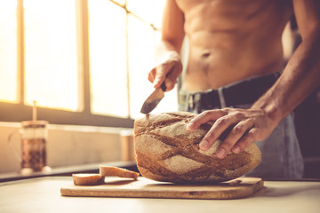 Sexy young man in kitchen