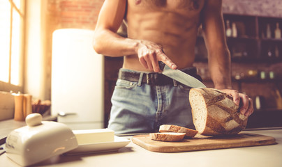 Sexy young man in kitchen