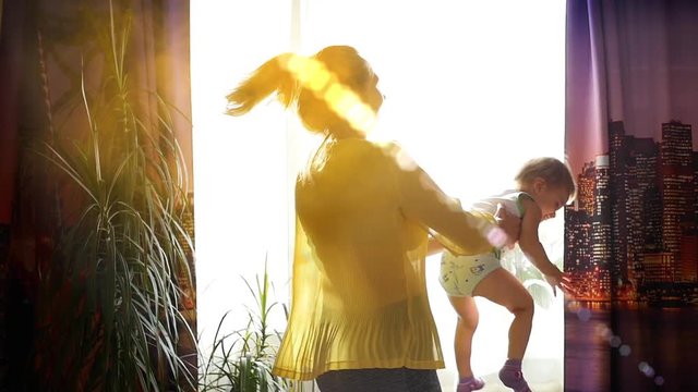 The Girl With Child Dancing In The Sunlight