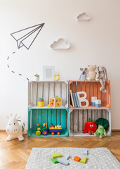 Colorful children room with vintage, wooden boxes. Washi tape decoration.