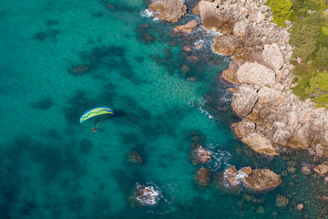 Naklejka na ściany i meble aerial view of the paraglider over the coast line