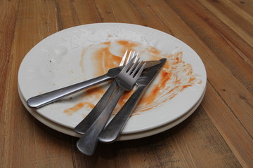 Dirty dinner plates and cutlery ready to be washed up