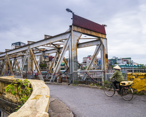 Crossing the Long Bien Bridge by bike, Hanoi, Vietnam

