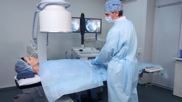 Interventional radiologist performs endovascular surgery operation, uterine fibroid embolization