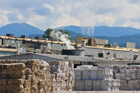 Bales of old paper in front of paper factory
