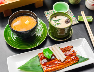 Premium quality grilled eel and miso soup served in Japanese restaurant. Asian food background