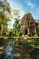 Fototapeta na wymiar Ancient Khmer pre Angkor architecture. Sambor Prei Kuk temple ruins with giant banyan trees under blue sky. Kampong Thom, Cambodia travel destinations