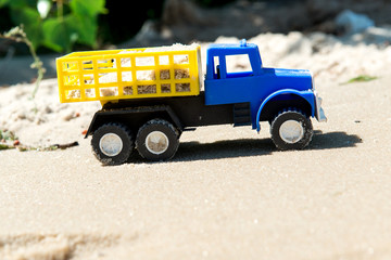Toy cars on the wet sand. Summer vacation at sea.