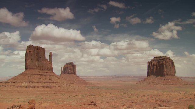 Wide shot of Monument Valley landscape with cloudy sky