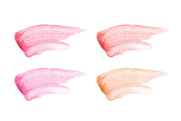 Different lip glosses isolated on white. Smudged lip gloss sample