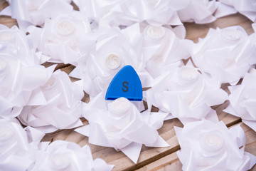 black and white plastic flower on wood pallet background