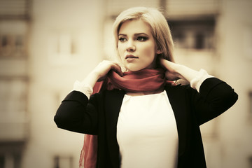 Young fashion business woman walking on city street