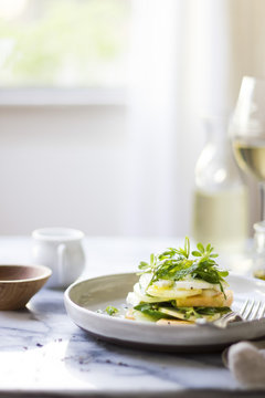 Cucumber melon caprese salad with rocket and purslane.
