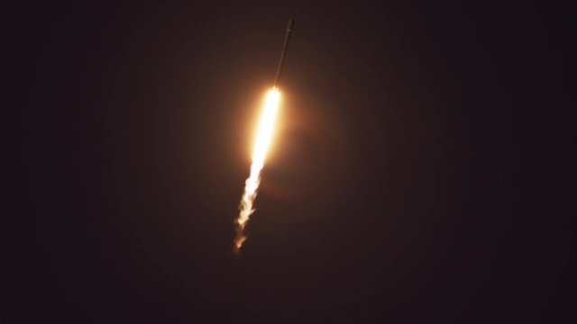 Slow motion of rocket flying in sky at night
