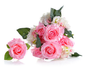 Obraz na płótnie Canvas Artificial pink roses on white background