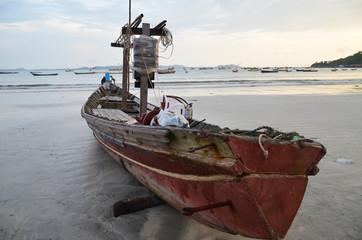 NGAPALI, MYANMAR- SEPTEMBER 27, 2016: Fisherman's boat fallen into ruin and disrepair on a beach