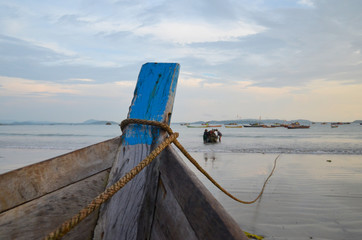 NGAPALI, MYANMAR- SEPTEMBER 27, 2016: Fisherman's boat fallen into ruin and disrepair on a beach