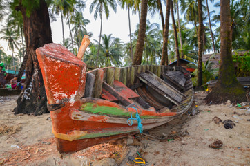 NGAPALI, MYANMAR- SEPTEMBER 27, 2016: Fisherman's boat fallen into ruin and disrepair on a beach