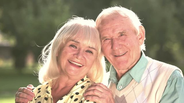Couple of seniors outdoors. Woman and man smiling. Love and kindness. Many years in marriage.