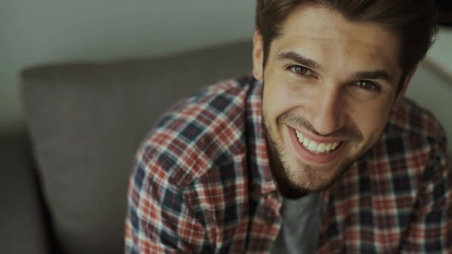 Happy young man. Portrait of handsome young man in casual shirt keeping arms crossed and smiling