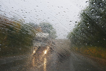 Raindrops on the windshield of the car.