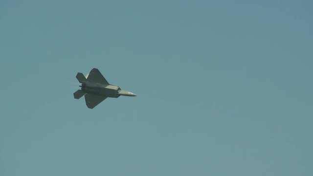 Slow motion of F22 fighter jet flying in sky