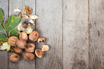 walnut on wooden background with leaves