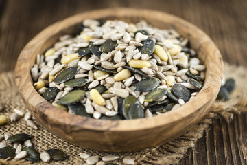 Old wooden table with mixed Seeds (selective focus)