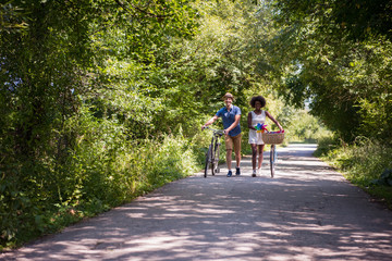Fototapeta premium Young multiethnic couple having a bike ride in nature