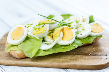 Portion of sliced Eggs (on wood)