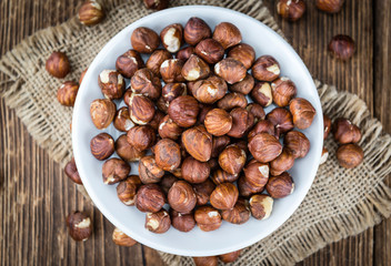 Hazelnuts on vintage wooden background (selective focus)
