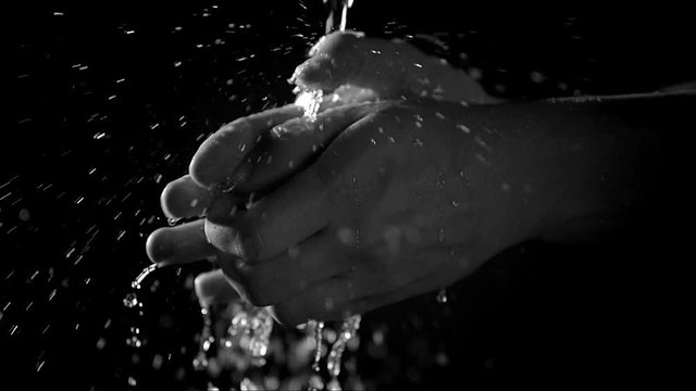 Close up of man washing hands with water