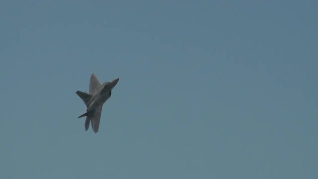 Tracking shot of F22 fighter jet flying in sky